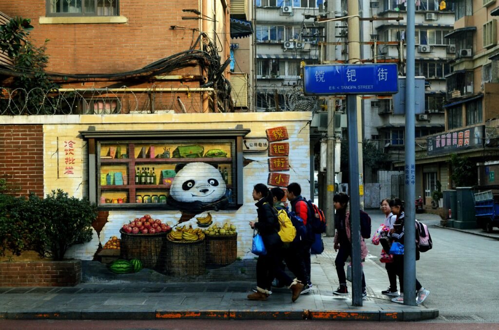 Vibrant street corner with urban graffiti art and a group of people walking by.